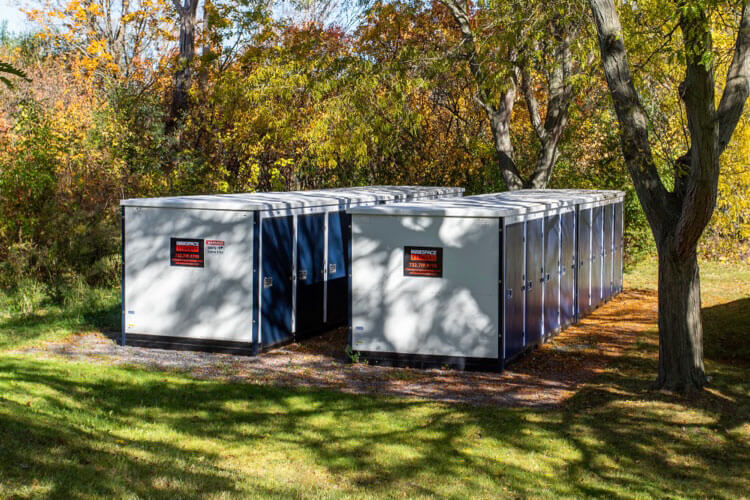 storage units under the shade of a nearby tree